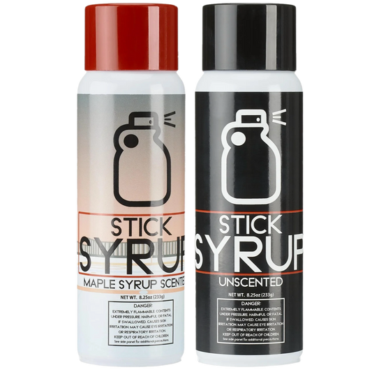 Two bottles of Stick Syrup, one with a red cap and one with a black cap, on a white background.